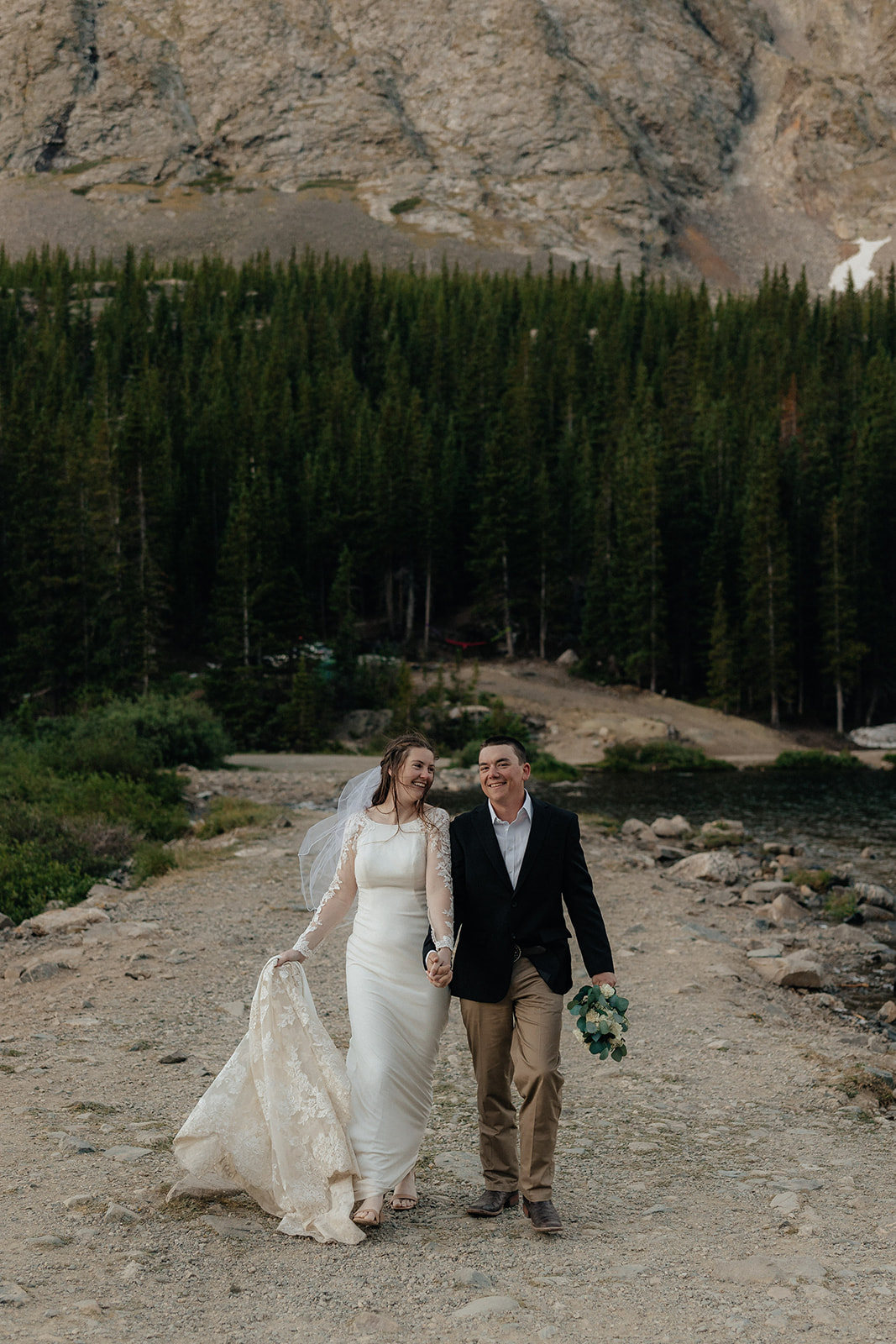 Destination elopement photographer captures bride and groom walking hand in hand after elopement ceremony