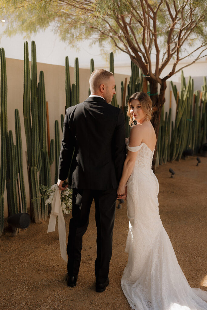 Destination elopement photographer captures bride holding groom's arm