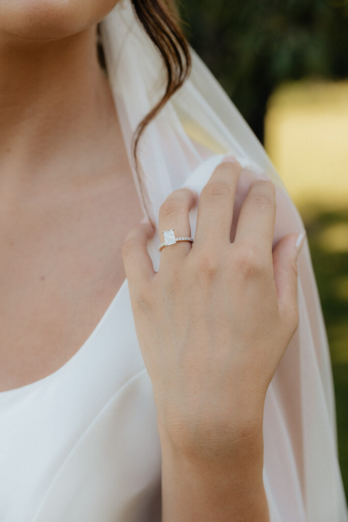 Tennessee wedding photographer captures bride holding hand up to shoulder showing off wedding ring