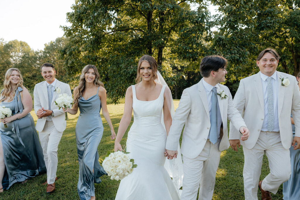 Tennessee wedding photographer captures bride and groom walking with wedding party