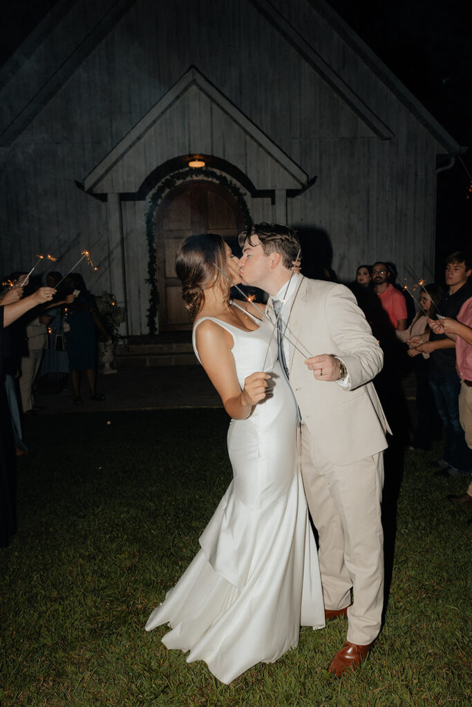 Tennessee wedding photographer captures couple kissing during sparkler exit