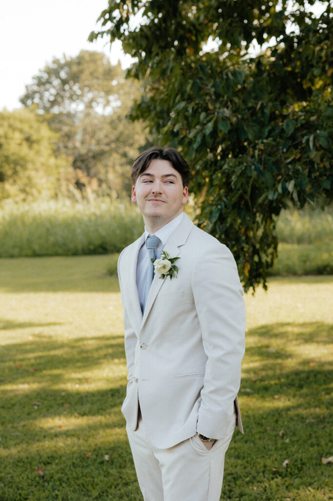 Tennessee wedding photographer captures groom wearing tan suit and smiling at camera