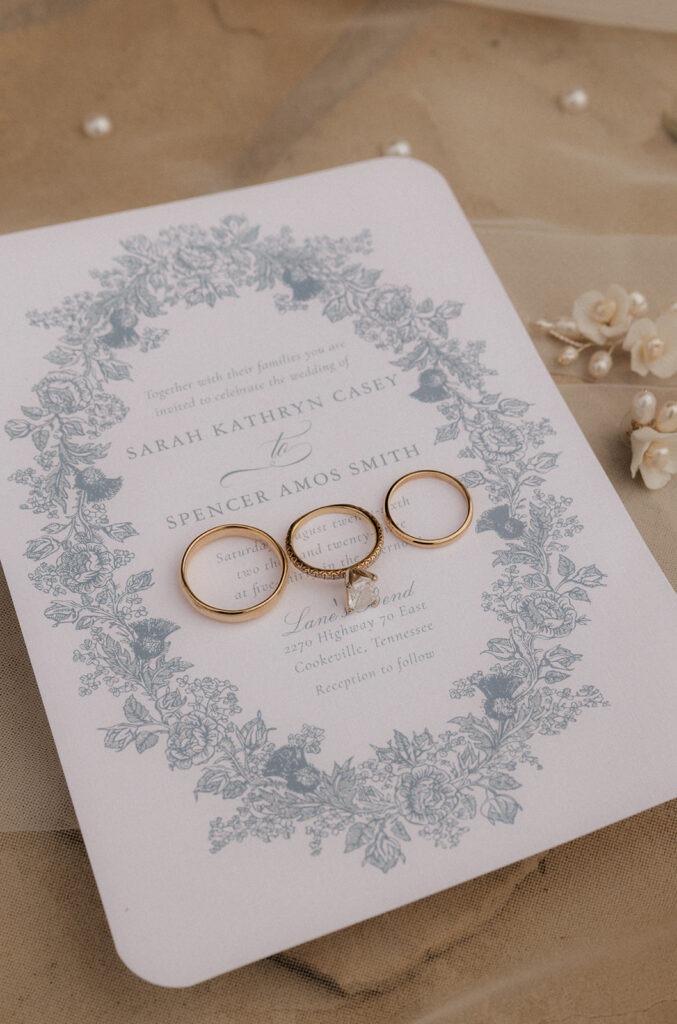 Tennessee Wedding Photographer captures close up of wedding invitations and wedding rings