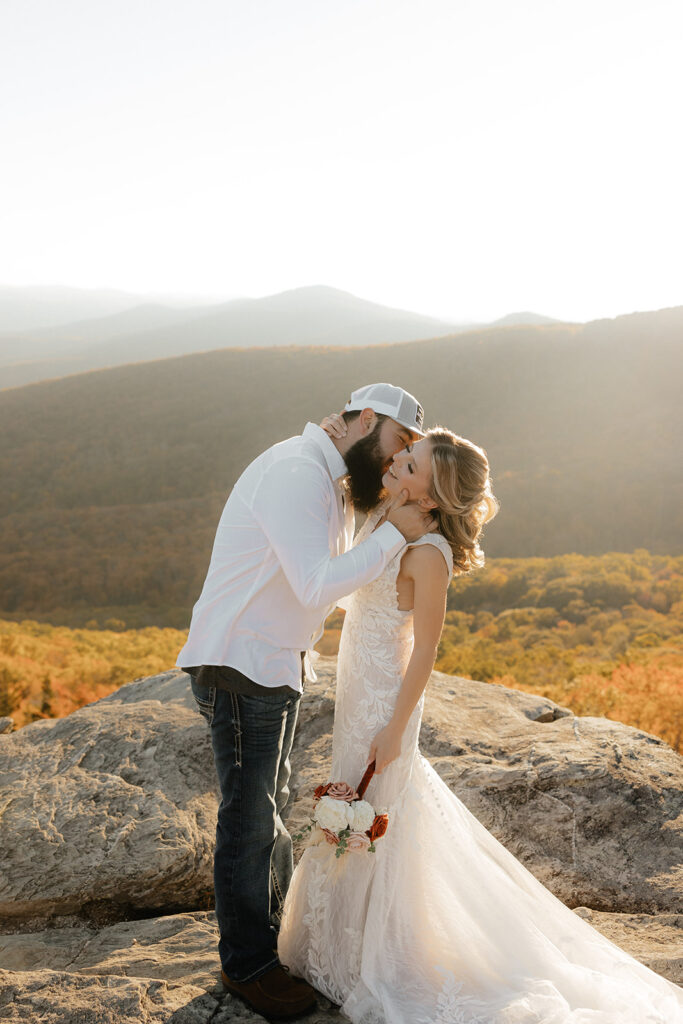 Destination wedding photographer captures bride and groom embracing on rock after epic wedding ceremony in Tennessee