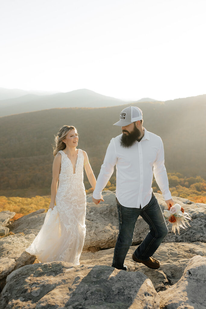 Destination wedding photographer captures groom holding bride's hand and leading her 