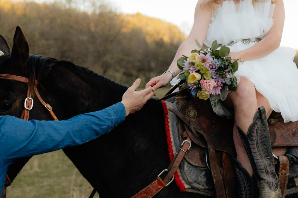 Couples engagement session with horse and florals, couple grabbing hands pose