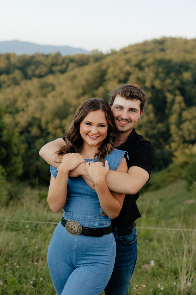 Tennessee elopement photographer captures man hugging woman from behind and smiling 