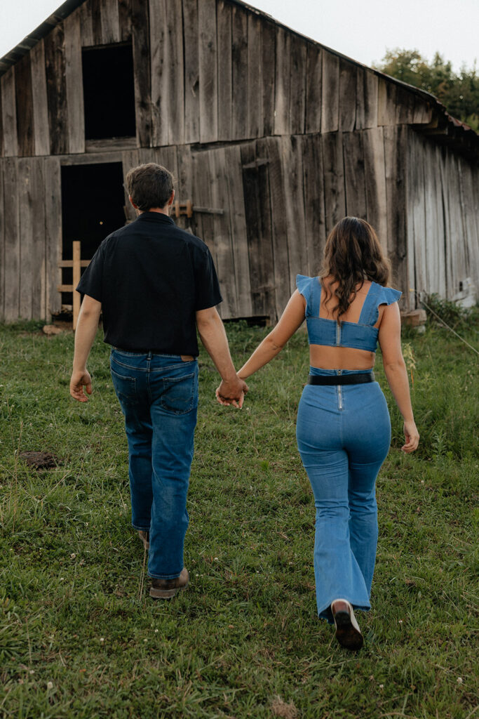 Tennessee elopement photographer captures couple walking towards barn