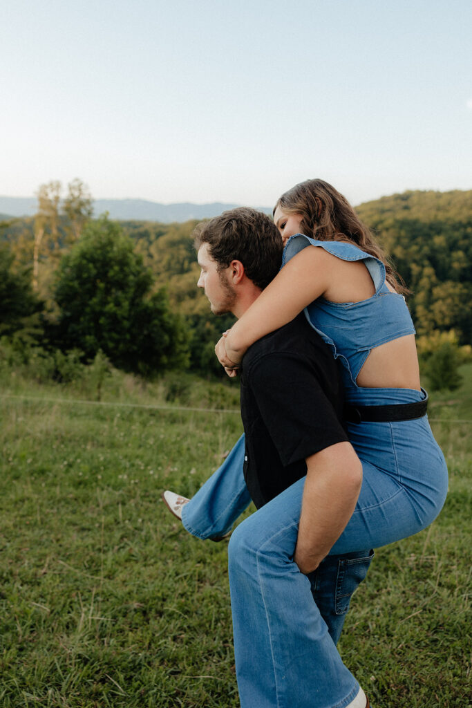 Tennessee elopement photographer captures man giving woman a piggy-back ride during engagement photos