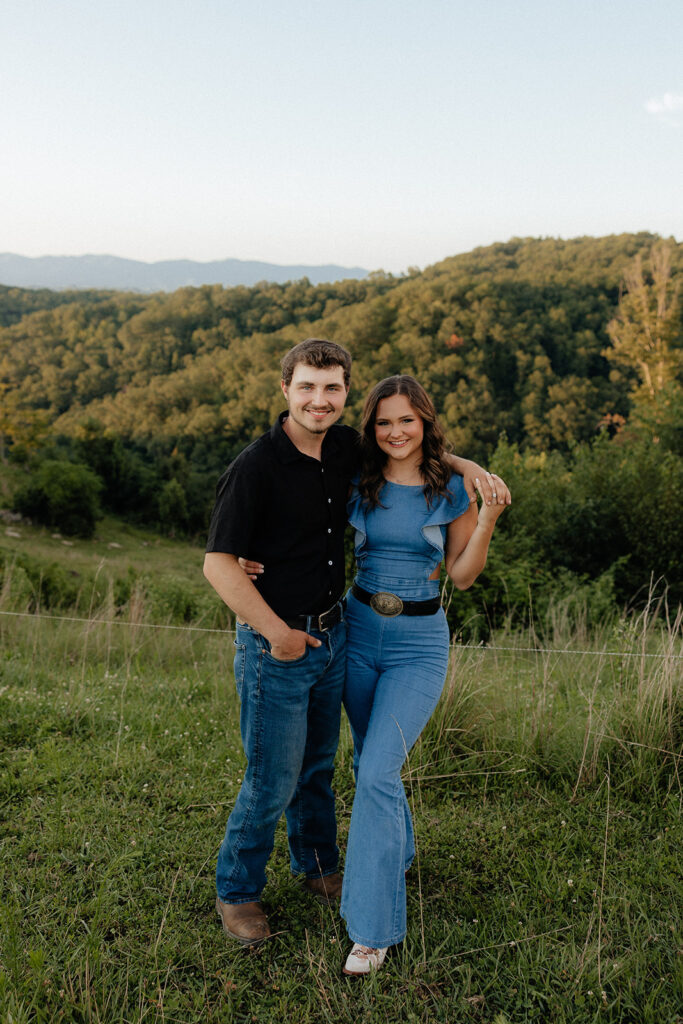 Tennessee elopement photographer captures man with arm around fiance during mountain engagement photos