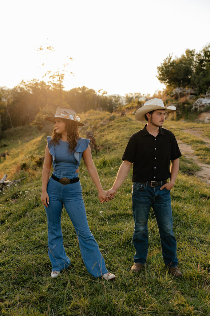 Tennessee elopement photographer captures newly engaged couple holding hands during western inspired engagement photos