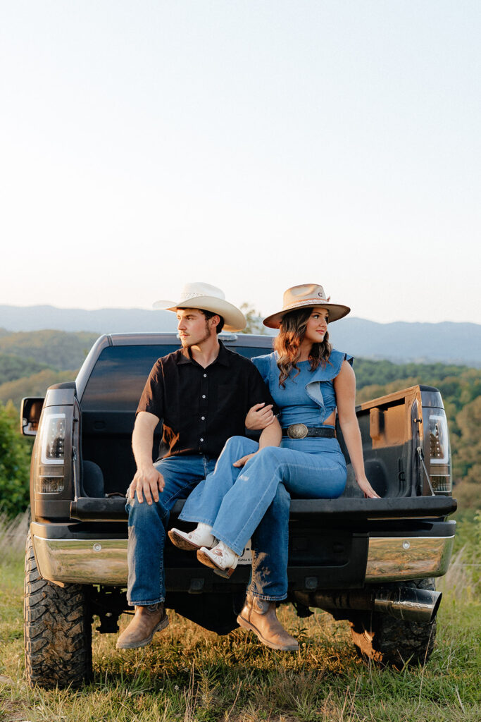 Tennessee elopement photographer captures newly engaged couple sitting in the bed of their truck during engagements