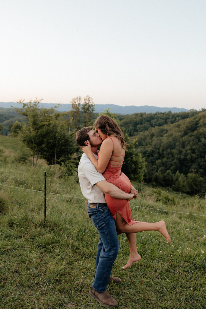 Tennessee elopement photographer captures man lifting woman and kissing her