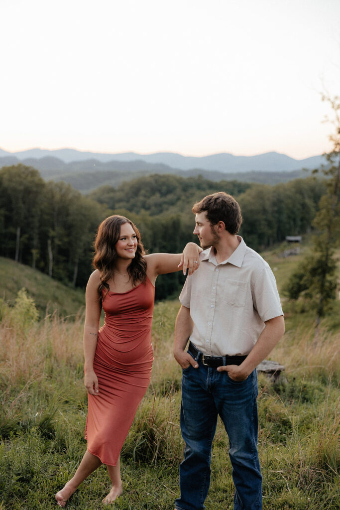 Tennessee elopement photographer captures woman leaning on man during mountain engagement photos