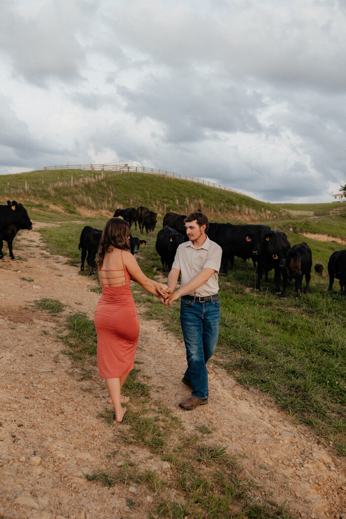 Tennessee elopement photographer captures man and woman dancing surrounded by cows